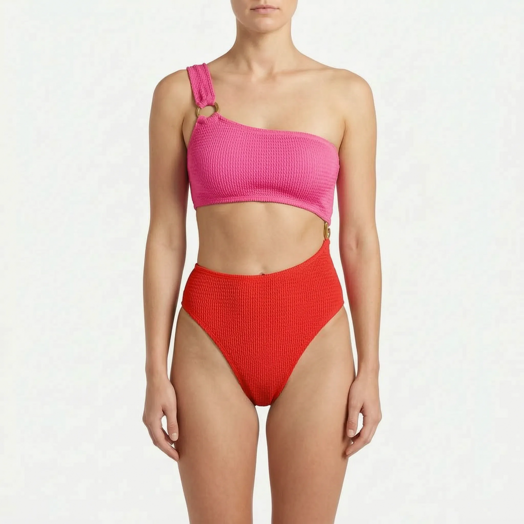 Chic women's asymmetric one-piece swimwear with a bold cut-out style, padded design & gold ring. Beach ready.