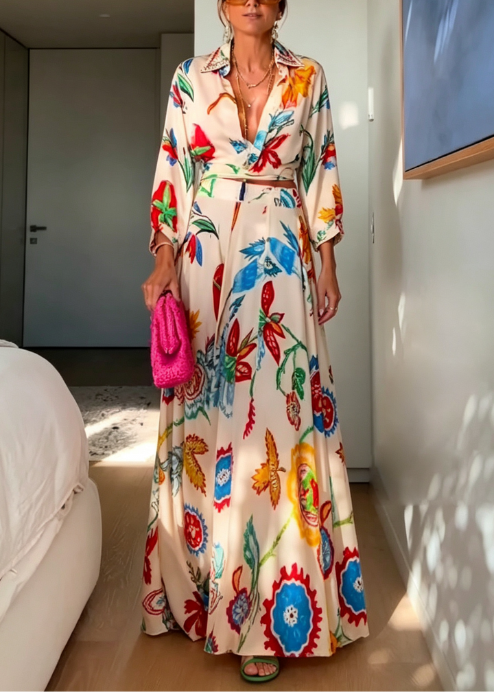 Coordinated women's beige floral two-piece outfit featuring a tie front top and maxi skirt.