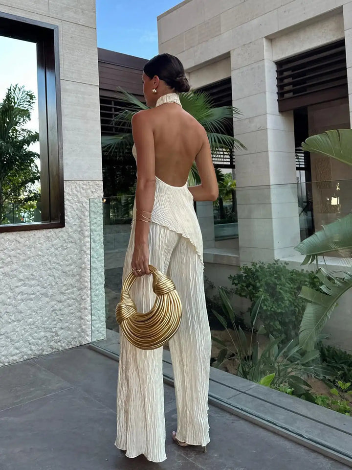 Elegant women's halter neck crop top & wide-leg pleated pants set, ideal for a chic summer look.