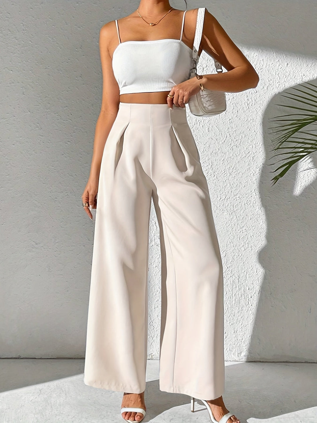 Comfortable women's beige high-waist wide-leg trousers, ideal for stylish summer outfits.