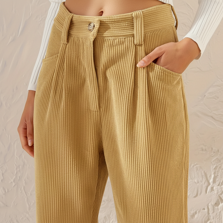 Fashionable women's high-waisted beige corduroy trousers, ideal for versatile autumn outfits.