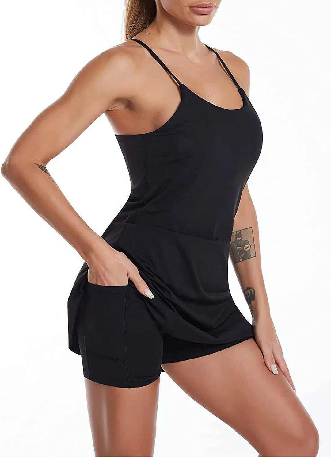 Women's black active sports dress with built-in shorts and side pockets, ideal for tennis or athleisure.