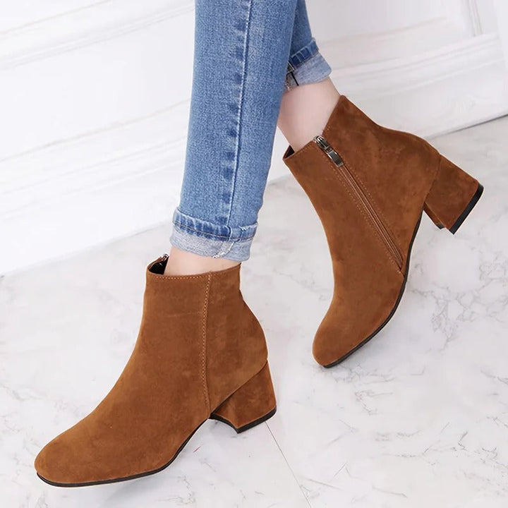 Women's black ankle boots with comfortable block heel & convenient side zip, perfect for everyday versatile style.