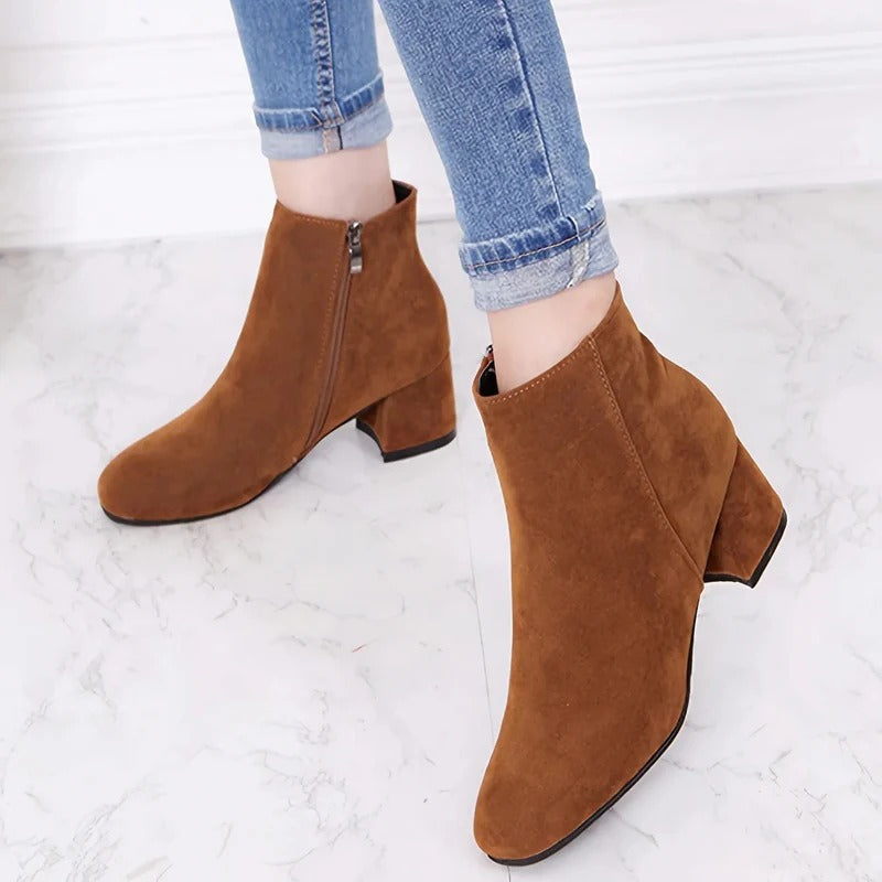 Stylish women's ankle boots, featuring a sturdy block heel & side zip, ideal for fall & winter fashion.