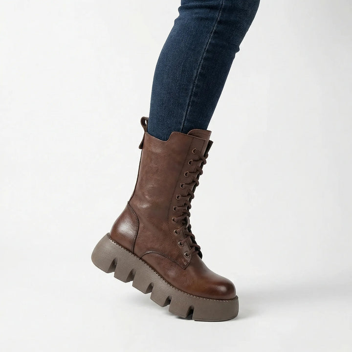 Trendy women's fall/winter combat boots. Black platform lace-up style with arch support for comfort.