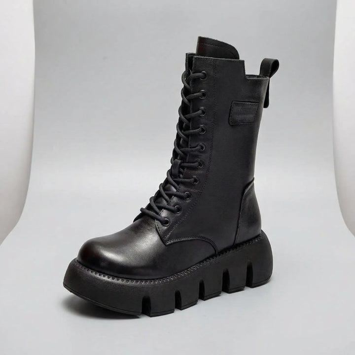 Women's high-traction platform combat boots. Lace-up design with arch support for comfortable everyday wear.