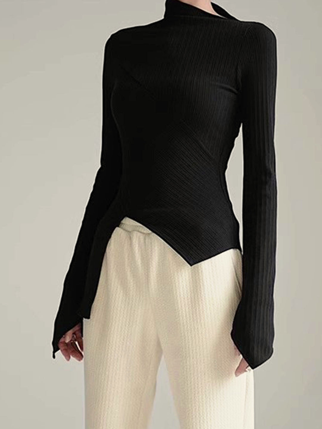 Women's asymmetrical black cutout long sleeve jumper, soft cotton blend, contemporary fashion.