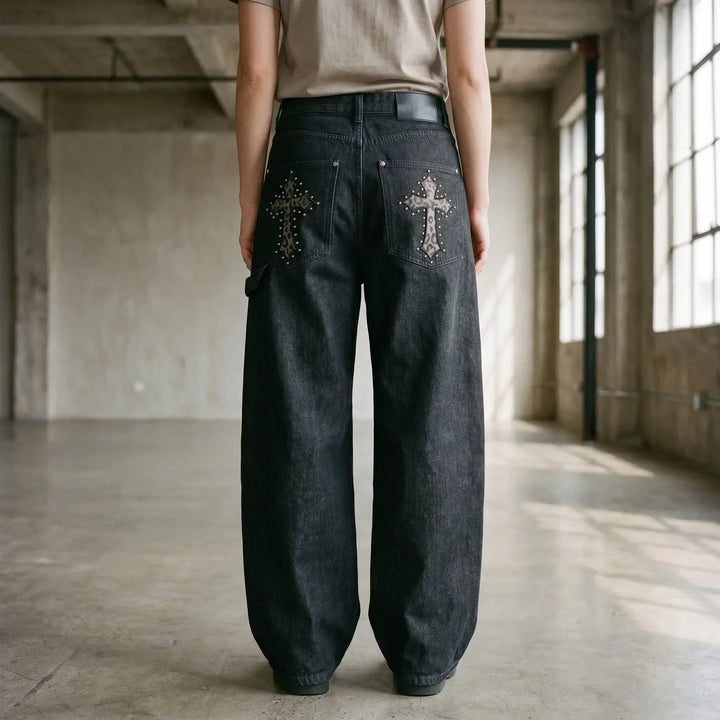 Women's black baggy wide-leg pants featuring a studded cross design, perfect for streetwear & grunge style.