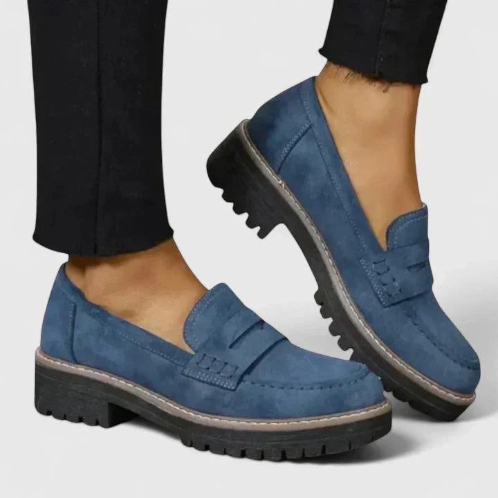 Stylish women's chunky platform penny loafers. Comfortable lug-sole slip-on footwear for a modern preppy look.