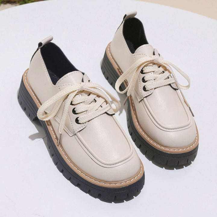 Women's black chunky platform loafers, a bold statement for fashion-forward casual or dressy outfits.