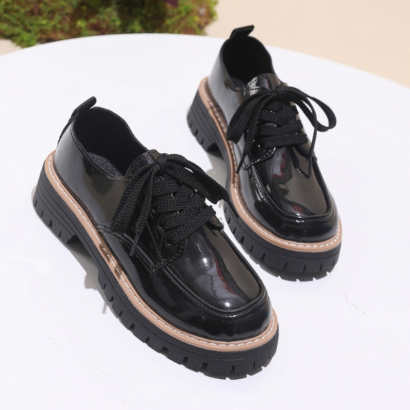 Elegant women's black chunky platform loafers, blending classic style with a comfortable, elevated sole.