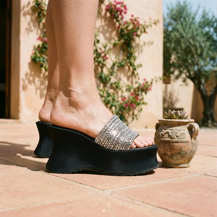 Women's black chunky platform sandals with an elevated sole, perfect for summer fashion and comfort.