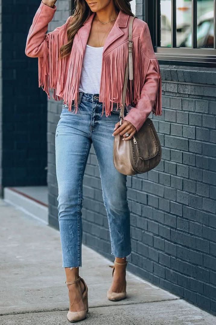 Chic women's biker jacket with stylish fringe detail. Edgy outerwear for fashion-forward looks.