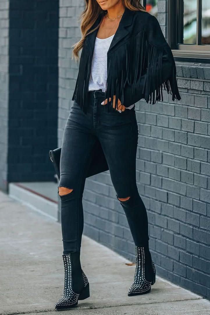 Close-up of a women's fringed moto jacket, highlighting the dynamic fringe and premium material.