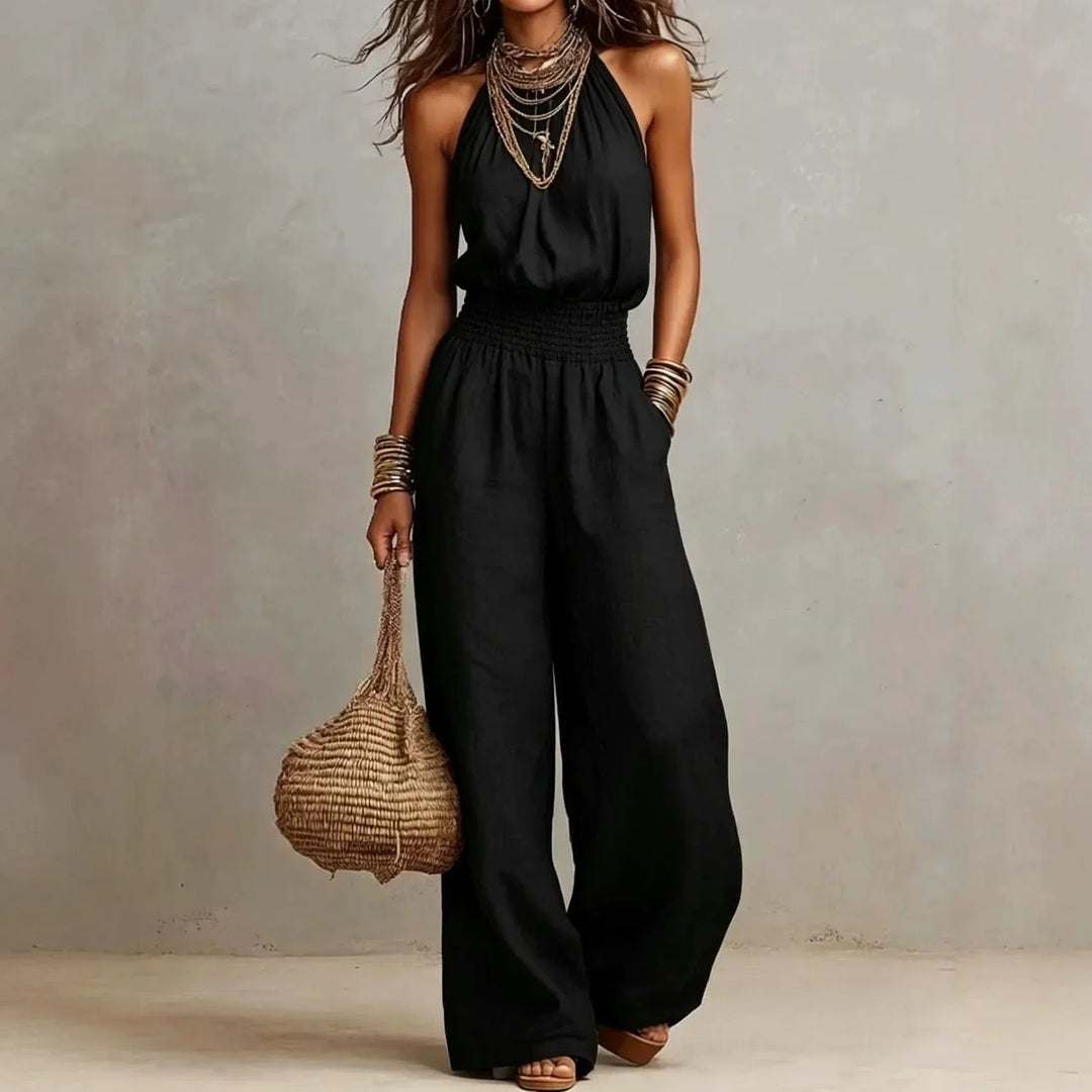 Red sleeveless halter neck wide leg jumpsuit for women. Stylish one-piece summer outfit, perfect for vacation.