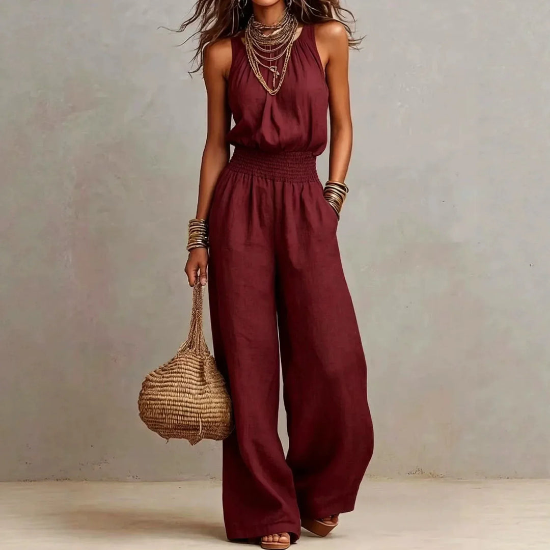 Comfortable women's halter neck wide leg jumpsuit. Features side pockets & a smocked waist for effortless style.