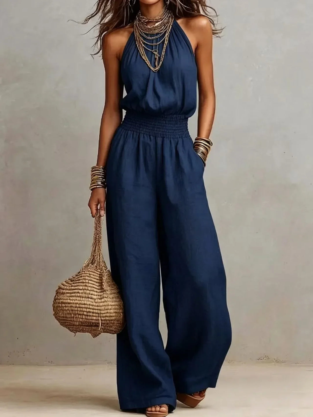 Versatile women's black wide leg jumpsuit. Halter neck, sleeveless design, ideal for summer casual or elegant wear.
