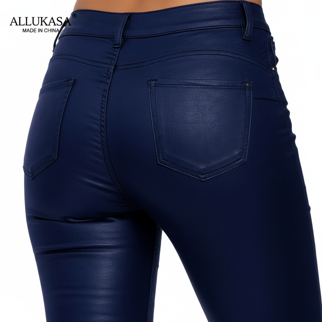 Close-up of the stretch faux leather texture on women's high-waisted trousers.
