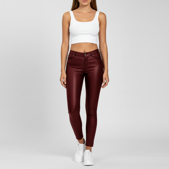 Detailed shot of pocket design on women's high-waisted faux leather pants.