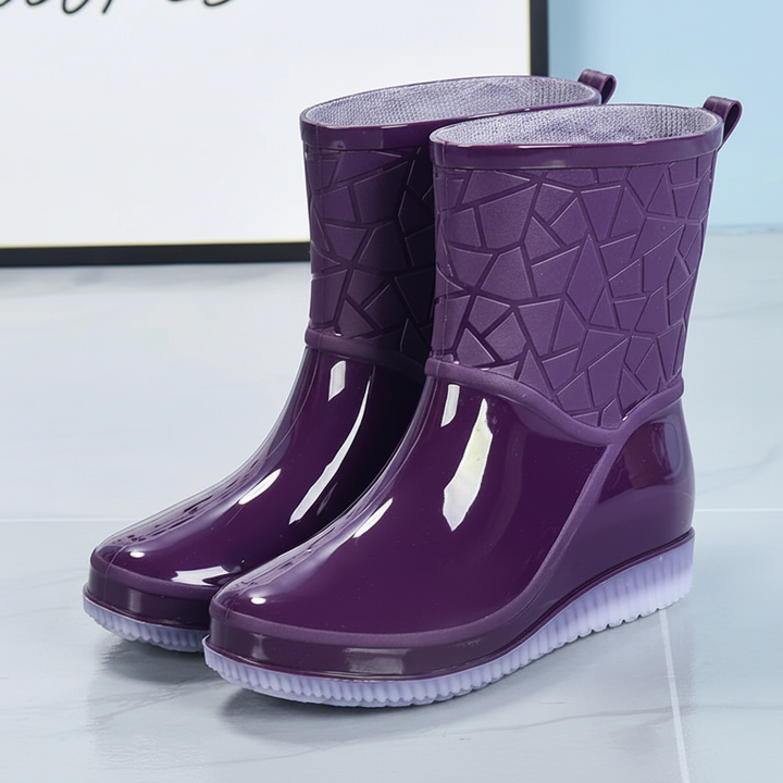 Fashionable women's mid-calf rain boots in black, ideal for wet weather, weatherproof design