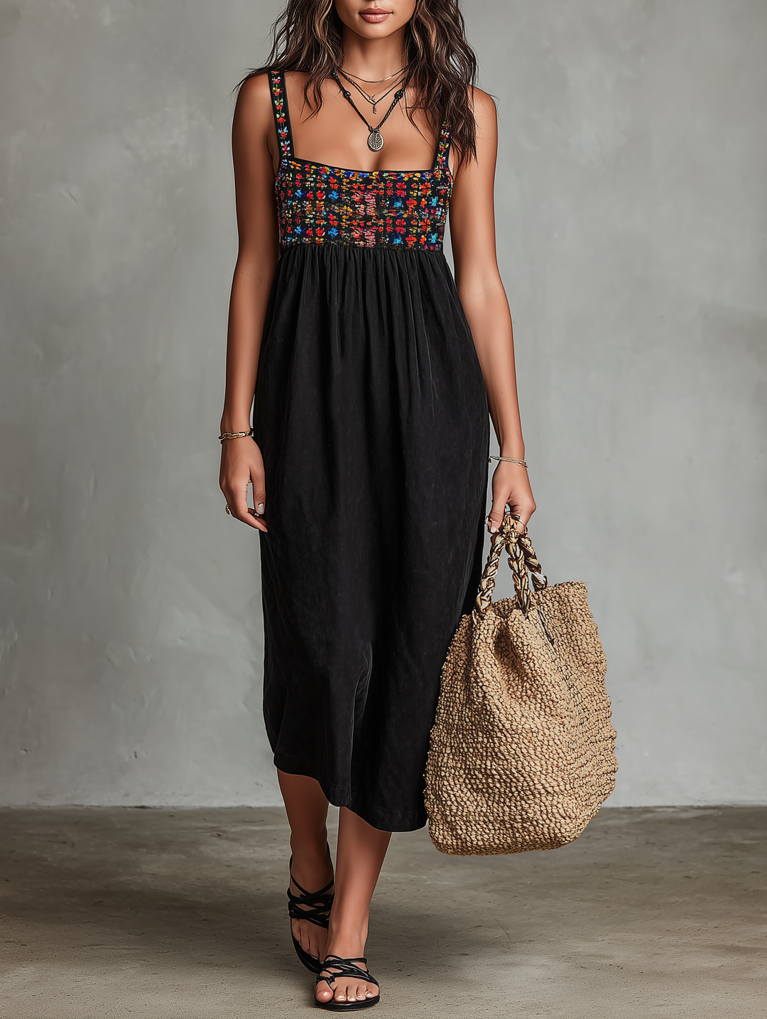 Women's black midi dress with square neck and vibrant floral embroidery, perfect for summer casual or elegant occasions.