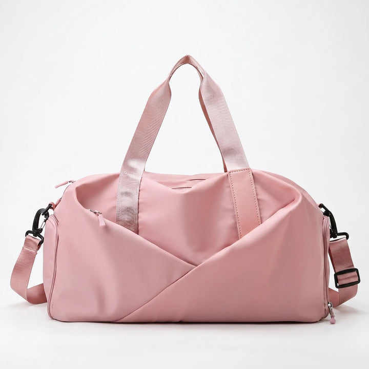 Active woman carrying a stylish black gym duffel bag with a shoe compartment, ready for a workout or trip.