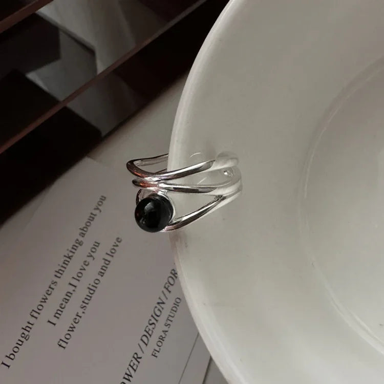 Women's black onyx multi-line ring in sterling silver, elegant gemstone jewelry.
