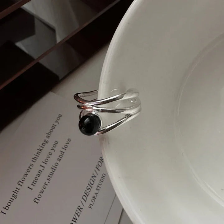 Women's black onyx multi-line ring in sterling silver, elegant gemstone jewelry.
