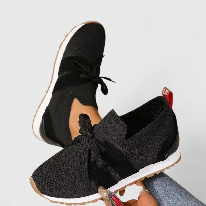 Women's black orthopedic slip-on walking sneakers with arch support, designed for all-day comfort and casual wear.
