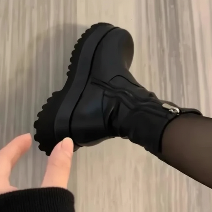 Close-up of warm lined women's platform Chelsea boots in black vegan leather, anti-slip sole