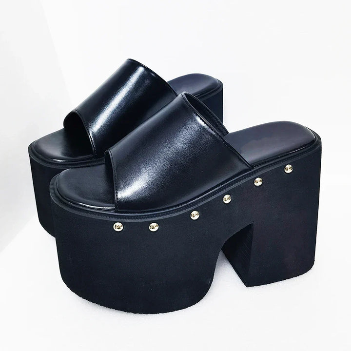 Fashionable black platform sandals for women, showcasing a dramatic block heel and open-toe summer style.