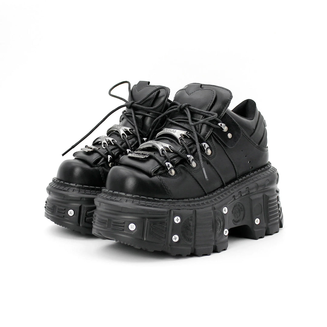 Women's black punk platform shoes with bold nail-studded chunky soles, perfect for alternative fashion.