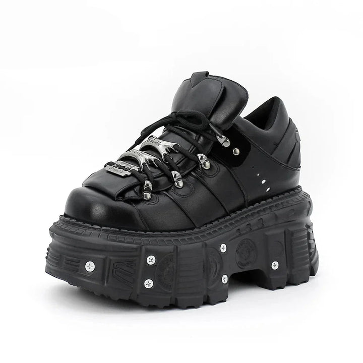 Lace-up women's rebel style platform boots featuring prominent nail-studded soles and a chunky design.