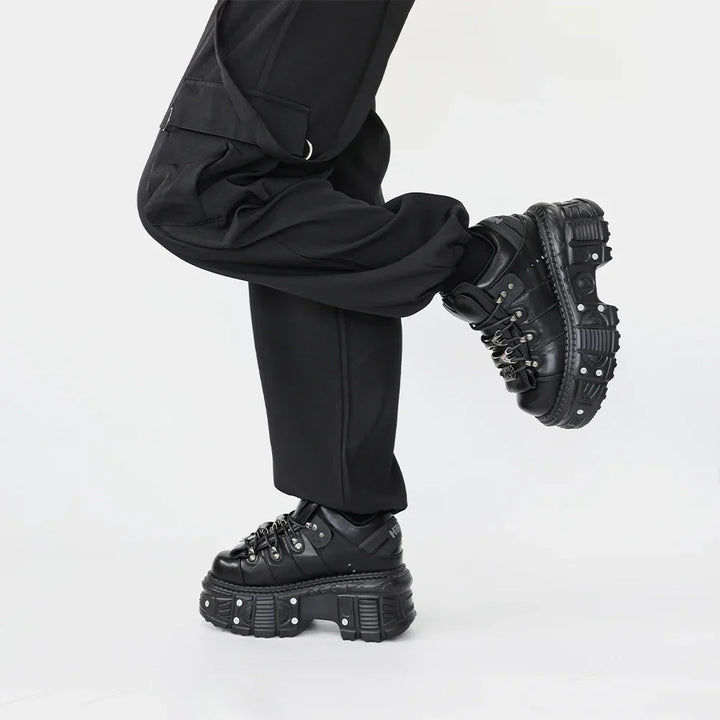 Black punk rock women's platform footwear with aggressive nail-studded soles & durable chunky design.