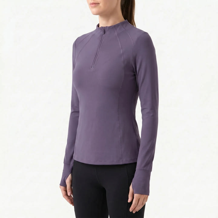 Stylish women's quarter-zip athletic top in black, a versatile long sleeve active layer for gym and running.