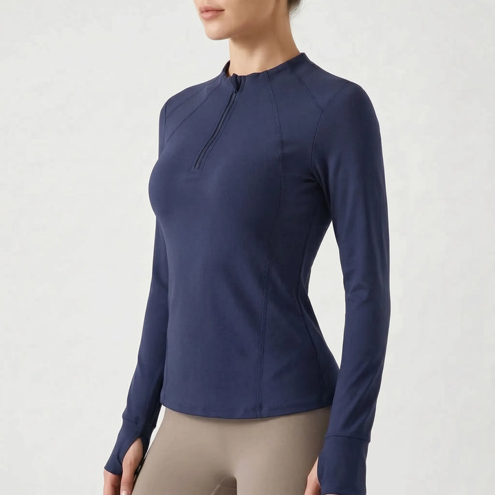 Comfortable women's long-sleeve quarter-zip performance top, moisture-wicking fitness apparel for intense workouts.