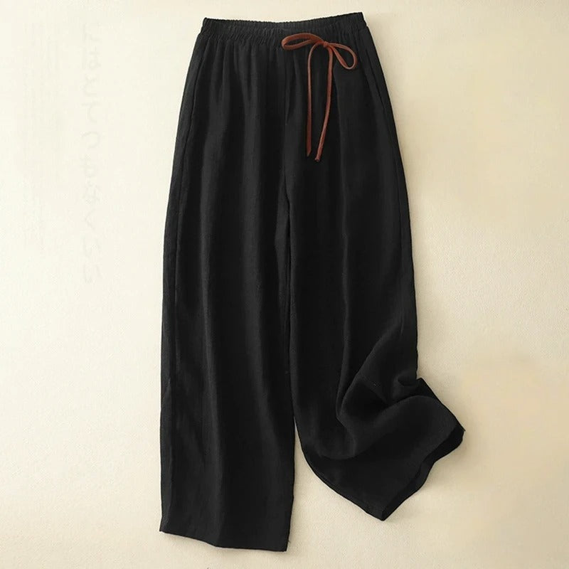 Women's black relaxed fit flowy wide-leg pants with gathered waist for effortless comfort and casual summer style.