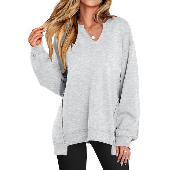 Pink women's relaxed fit V-neck tunic sweatshirt. Casual long-sleeve top, perfect for cozy comfort.