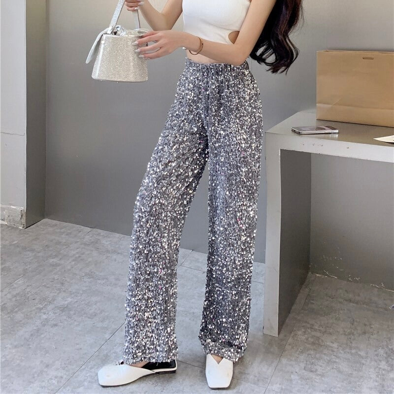 Elegant women's high-waisted party pants in a shimmering black fabric, suitable for evening events.