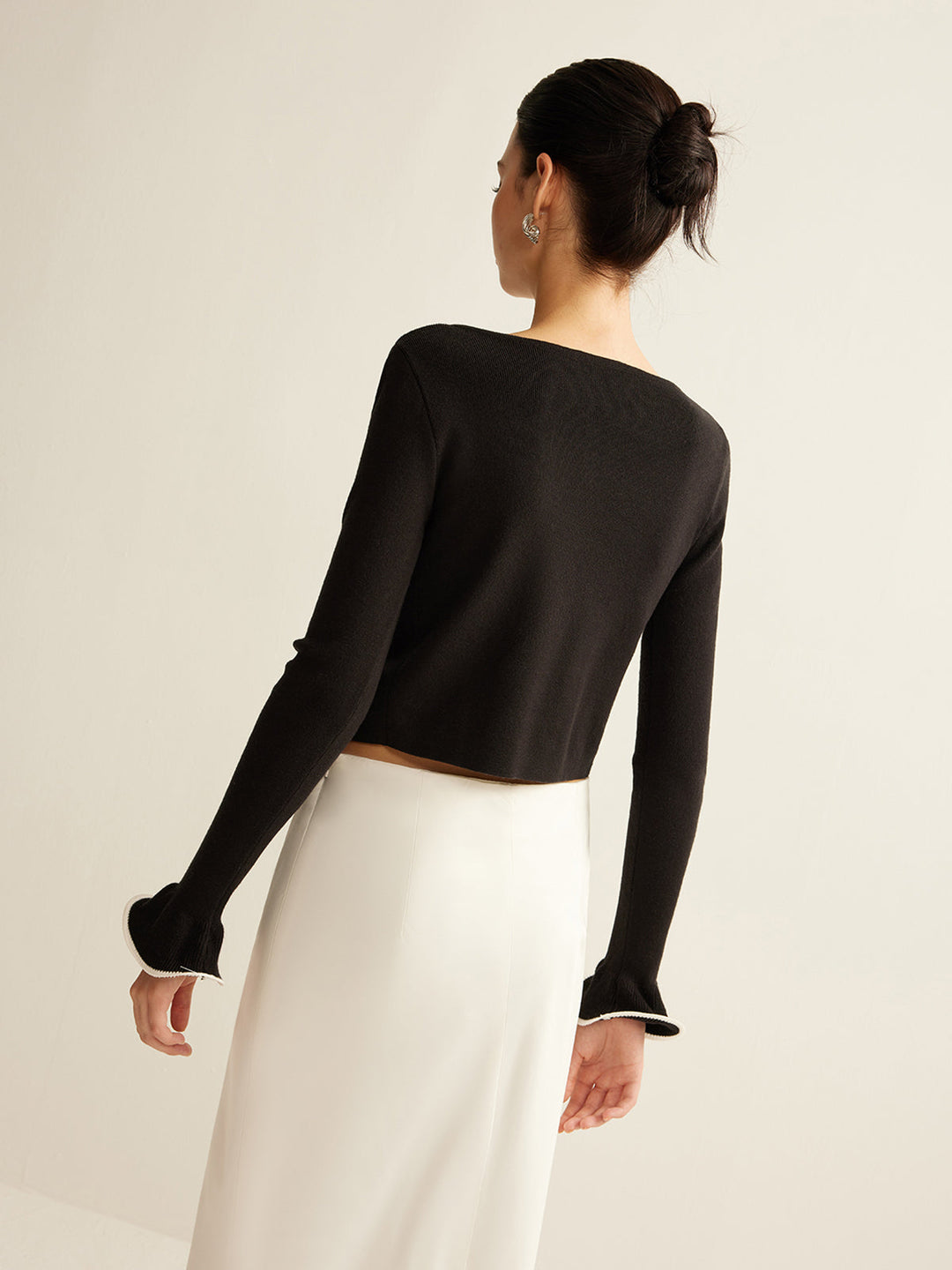 Black skinny ruffle cardigan for women. Perfect versatile layering piece for chic autumn & winter fashion.
