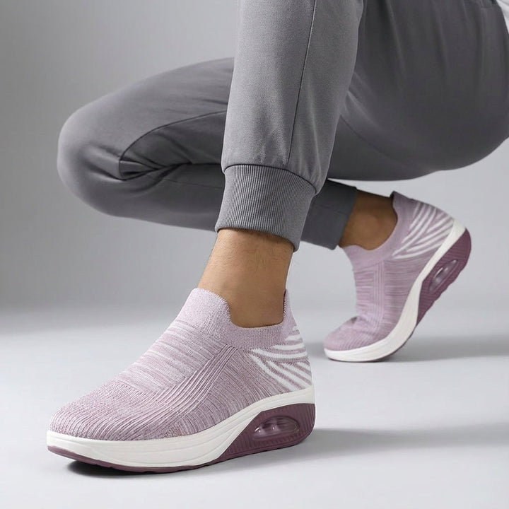 Pair of women's cushioned slip-on wedge sneakers, offering comfort and style.