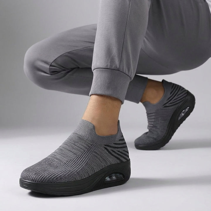 Women's slip-on wedge sneakers featuring a cushioned sole for all-day comfort.