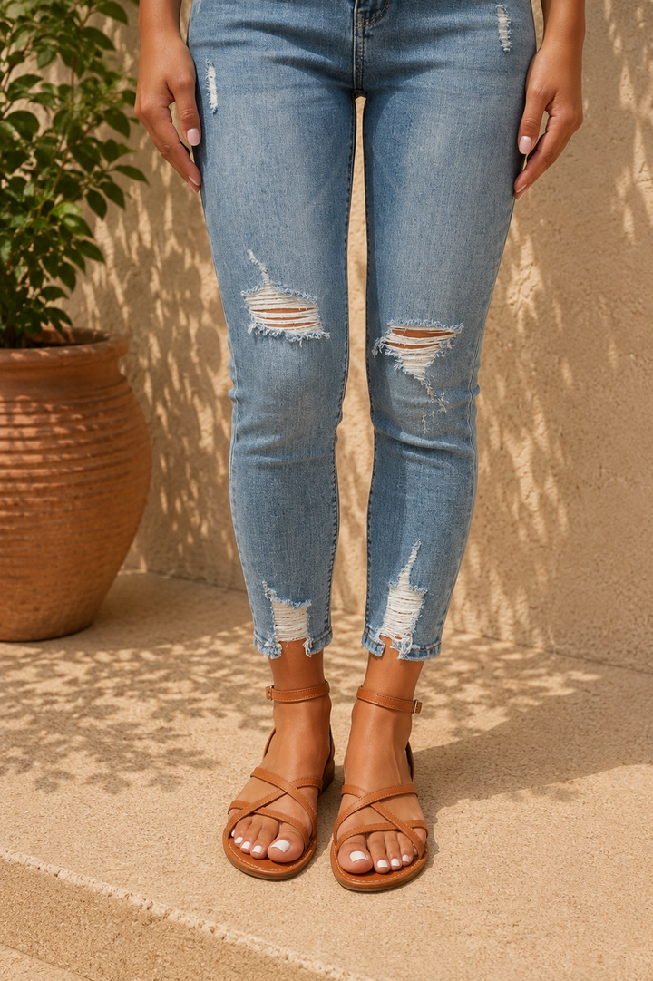Warm weather women's flat sandals featuring a secure ankle buckle and multi-strap design for comfort.