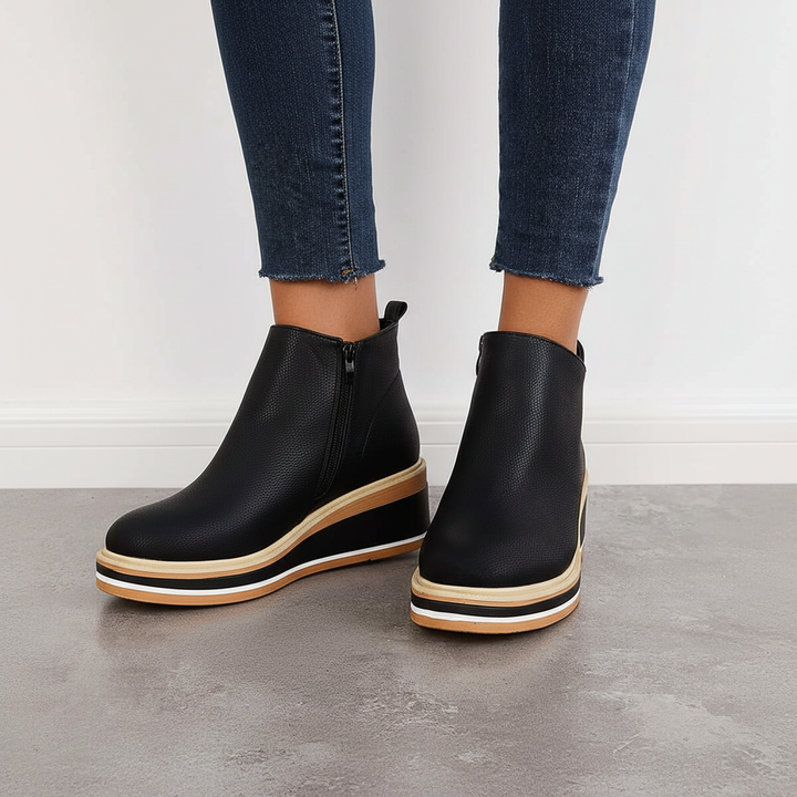 Close-up of the textured vegan leather on women's platform ankle boots, ideal for stylish autumn outfits