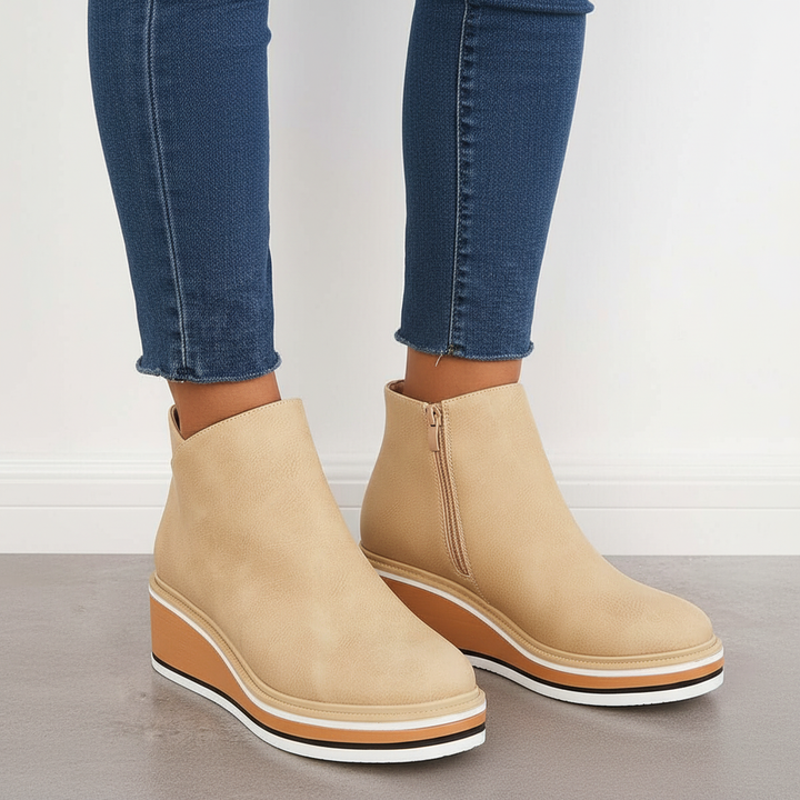 Side profile of women's black vegan leather platform ankle boots, highlighting the stylish design and autumn appeal