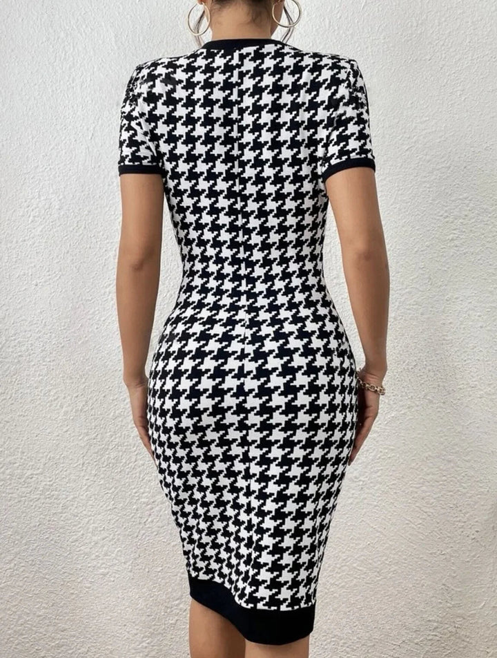 Chic black and white houndstooth midi dress for women, offering a sculpted and elegant bodycon fit.