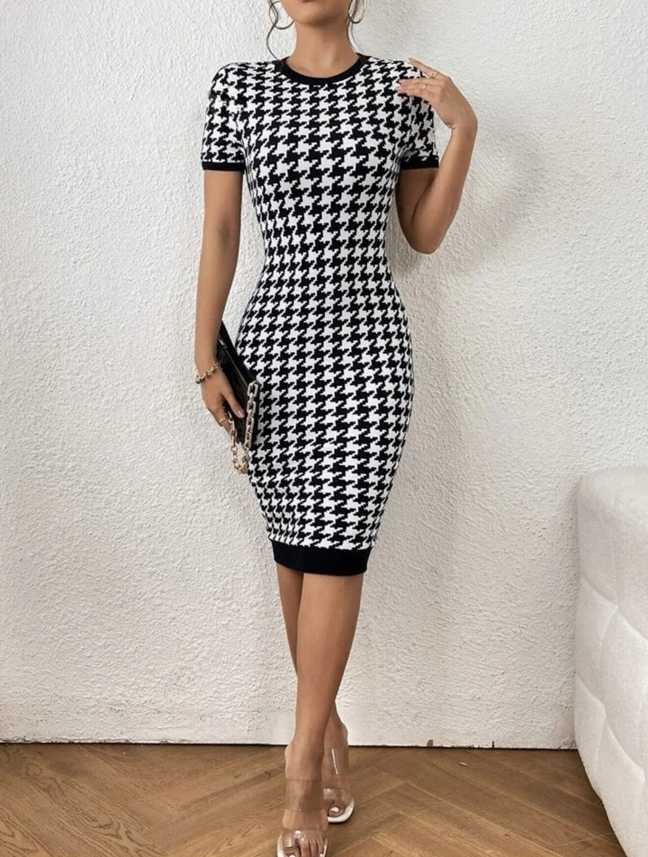 Flattering women's black & white houndstooth midi dress with a sculpted bodycon silhouette, ideal for occasion wear.
