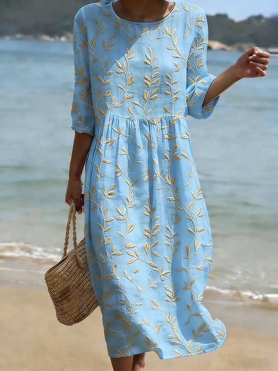 Women's blue leaf embroidered midi dress with three-quarter sleeves, perfect for summer garden parties or vacation wear.