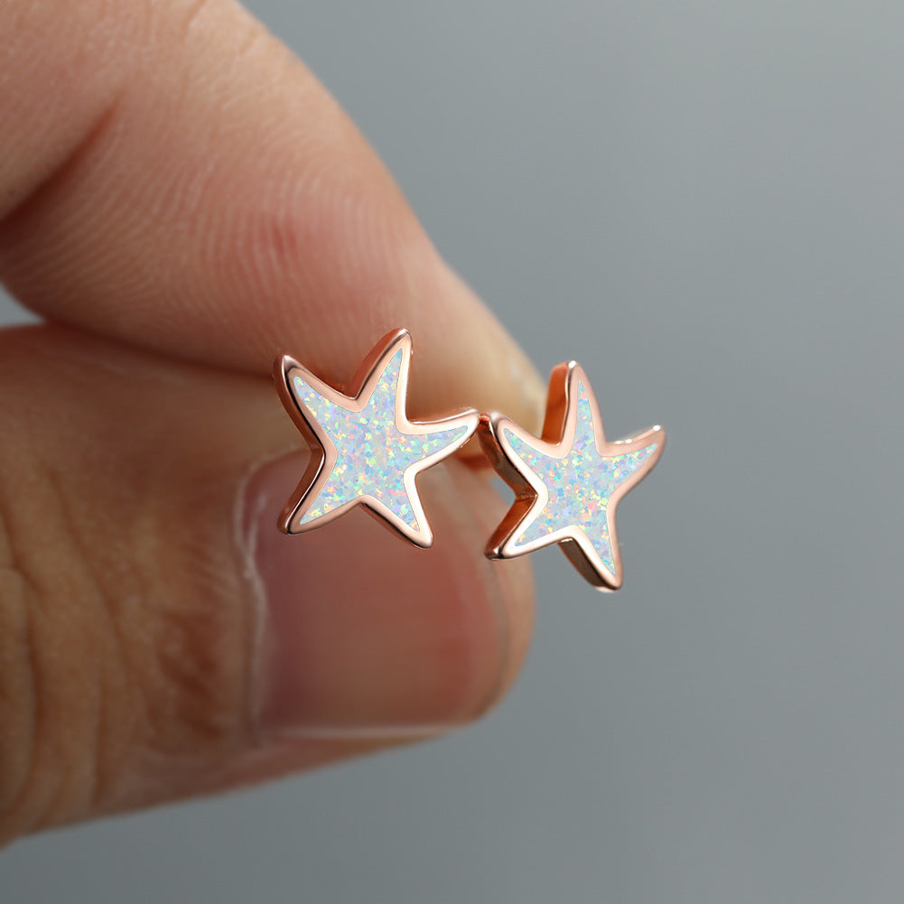 Women's blue opal starfish dangle earrings, elegant and perfect for any occasion.