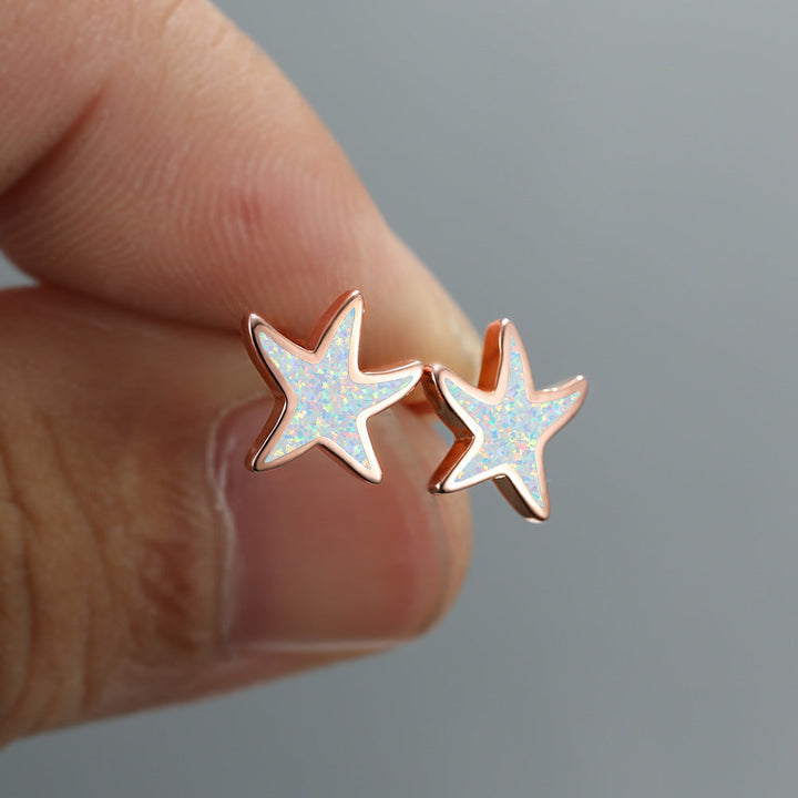 Women's blue opal starfish dangle earrings, elegant and perfect for any occasion.